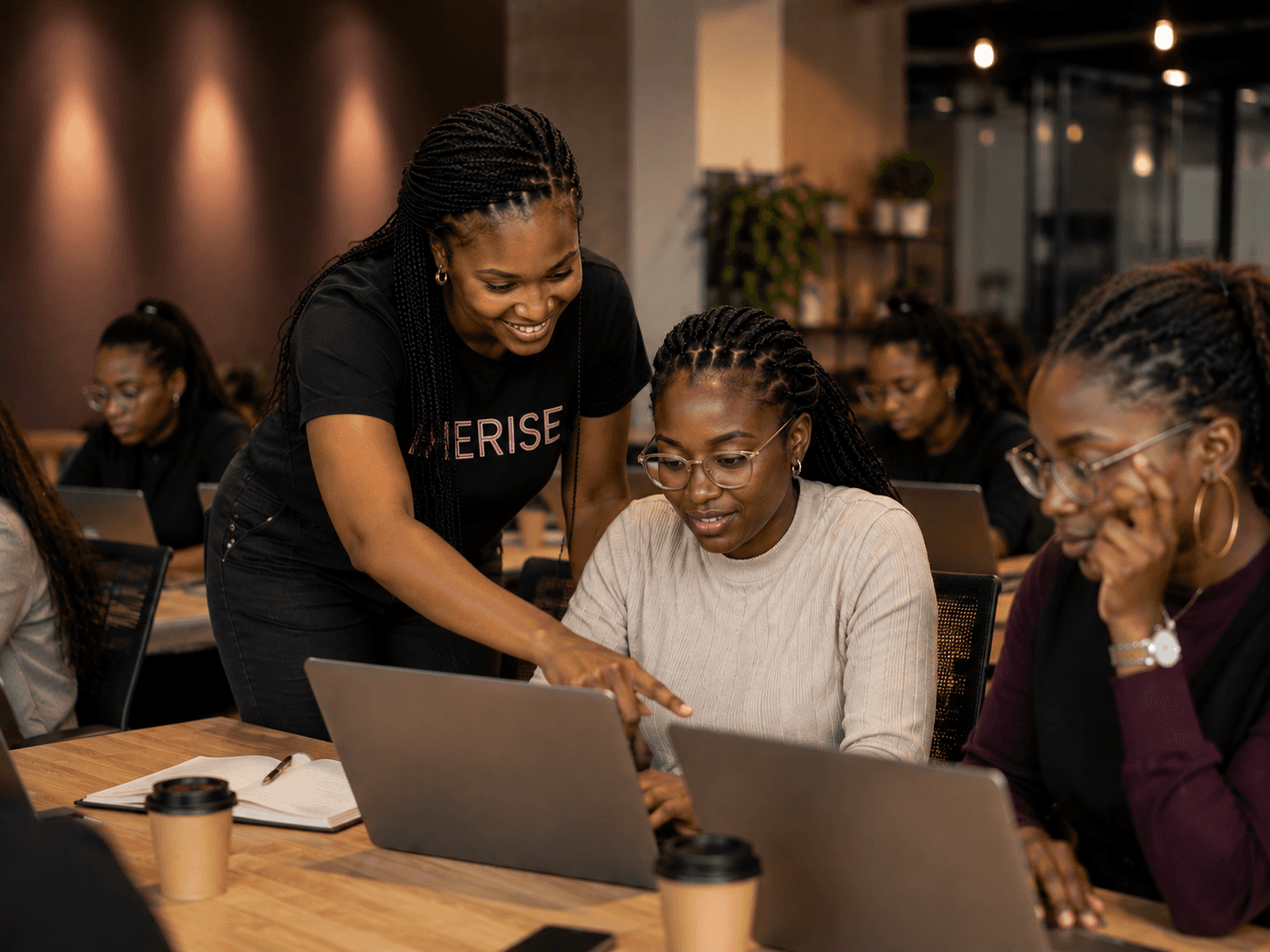 African female tech professionals engaged in a workshop